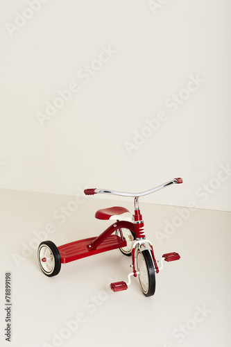 Red tricycle in studio