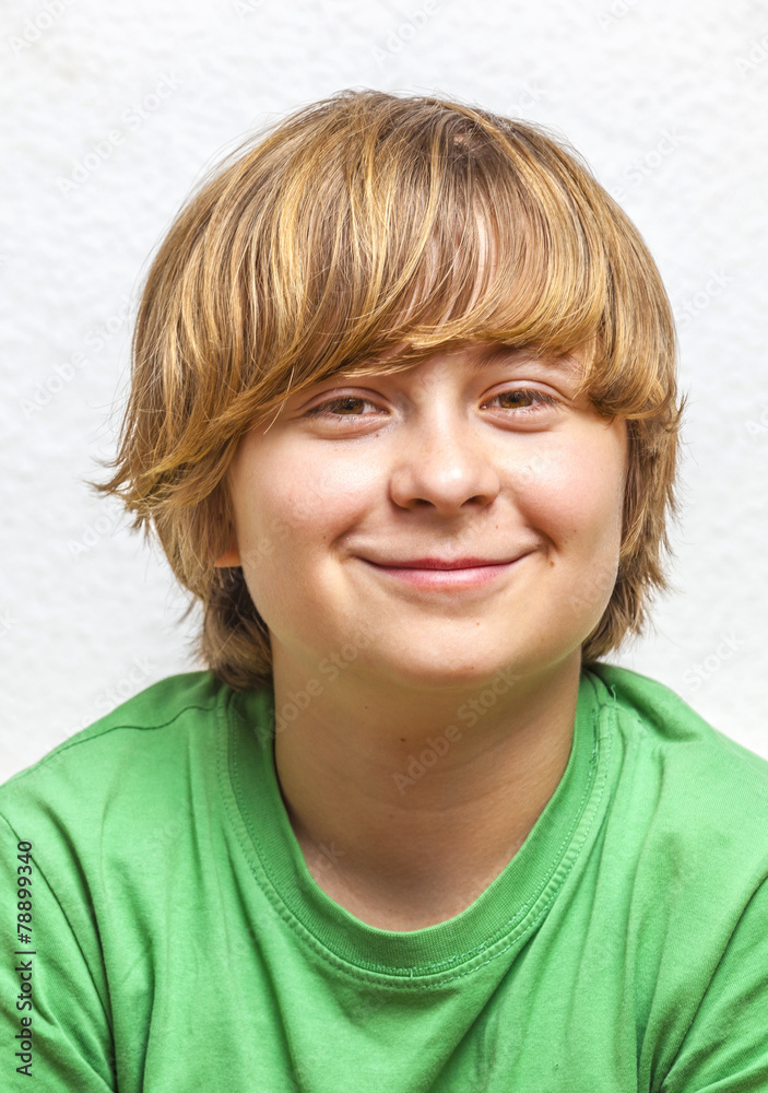 smiling boy sitting on a sofa smiling boy sitting on a sofa