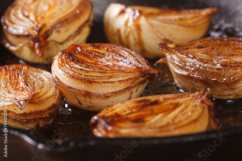 сaramelized onion halves with balsamic vinegar in a pan