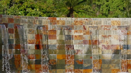 Waterfalls from a decorative wall made of nuanced slab slates
