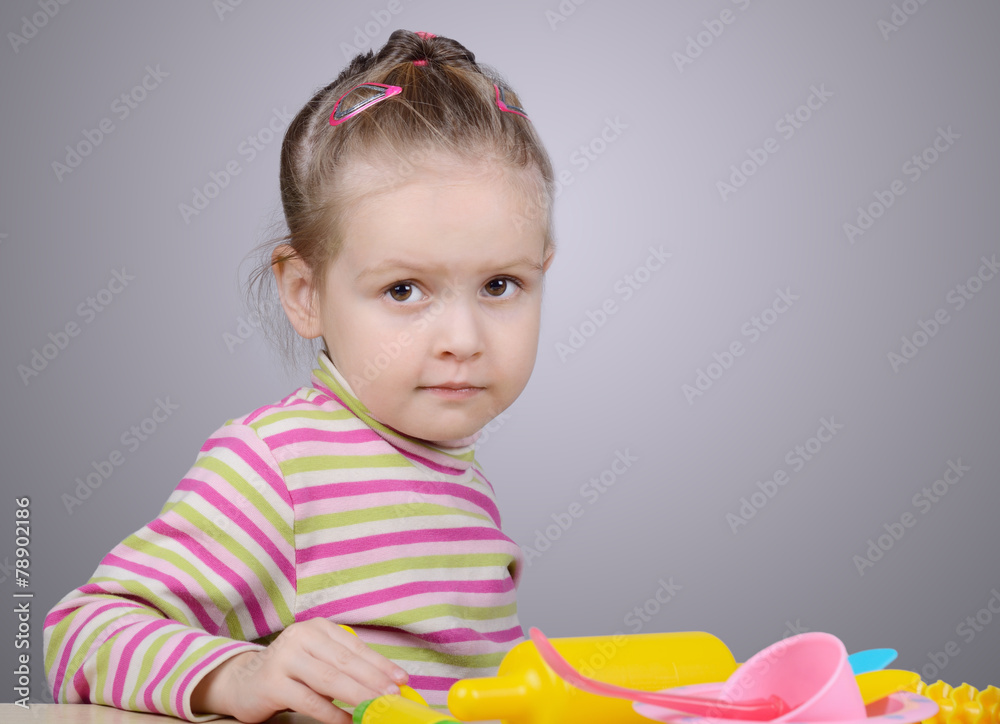 Girl playing with plastic tableware