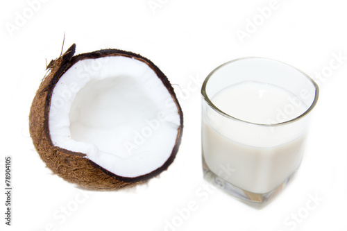 Glass with coconut milk on white background