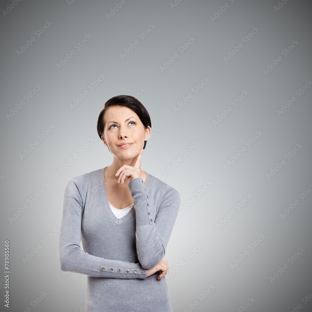 Pensive woman, isolated on grey background Pensive woman, isolated on grey background