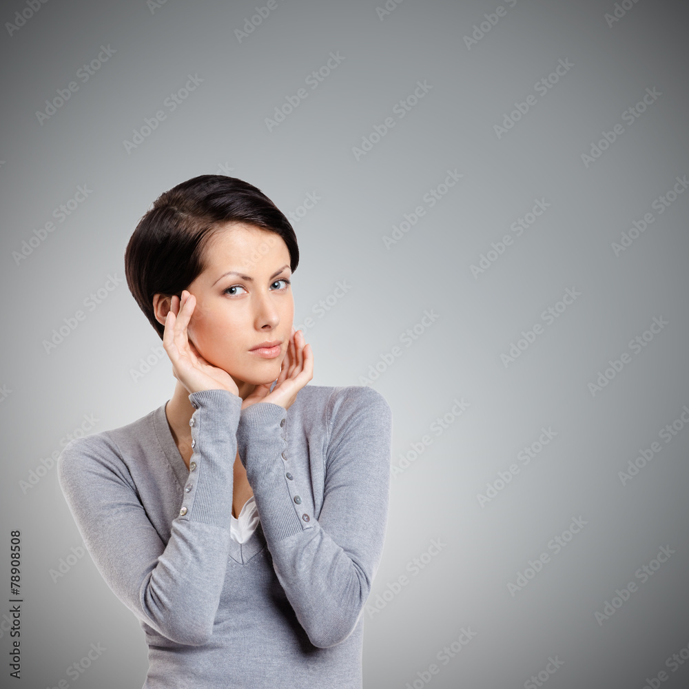 Ideal woman admires her own beauty, isolated on grey Ideal woman admires her own beauty, isolated on grey