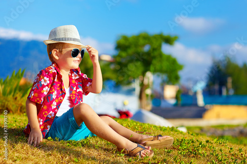 happy fashionable kid on summer meadow