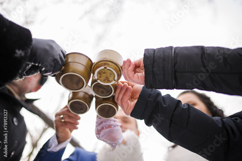 five friends toasting with hot drink winter