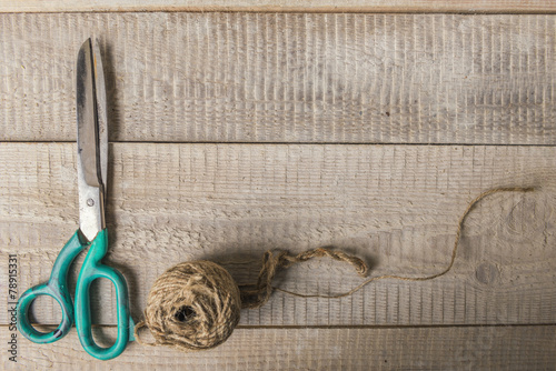 Old scissors and tailor on rustic wodden background