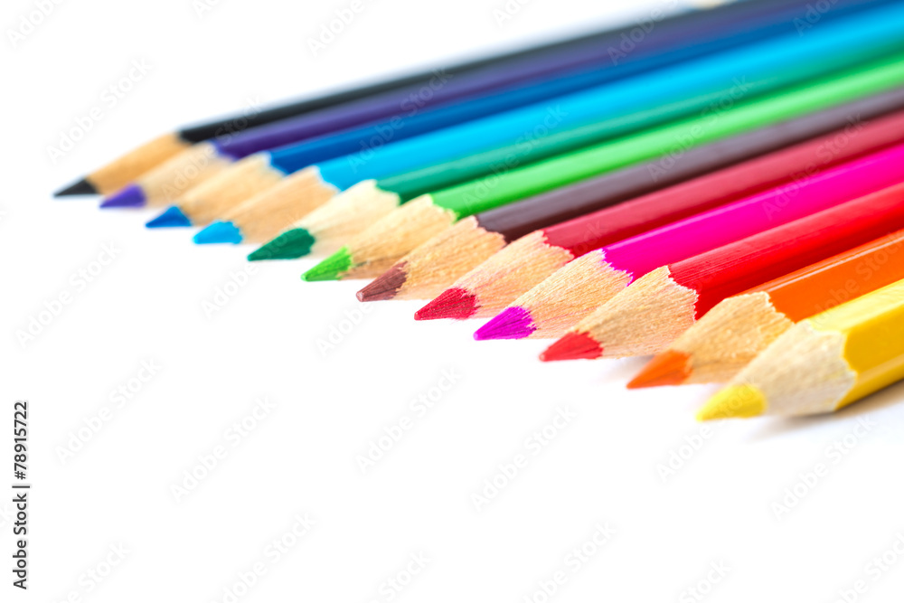 Colored pencils on an isolated background. Focus on the red Colored pencils on an isolated background. Focus on the red