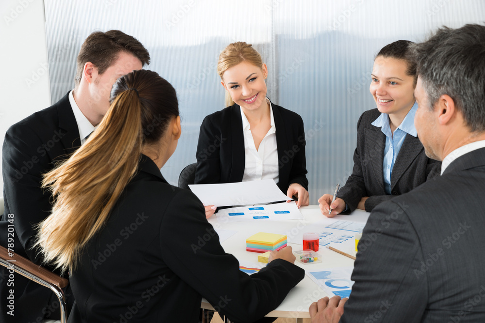 Businesspeople Analyzing Graph In Office Businesspeople Analyzing Graph In Office