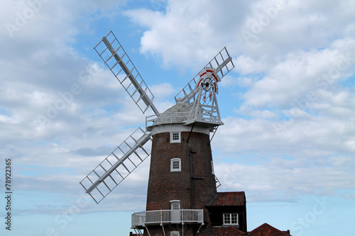 A Brick Built Traditional Windmill with Wooden Sails.