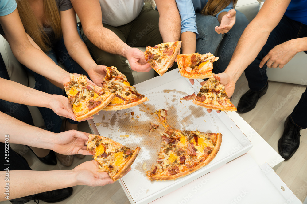 People Holding Pizza Slices
