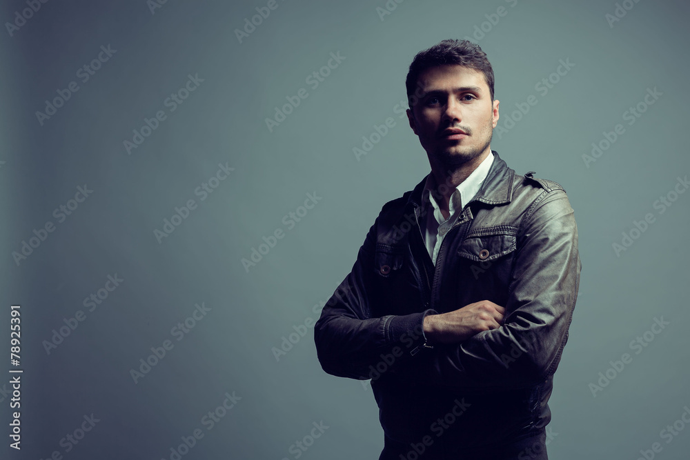 Handsome in style. Cheerful smart young man in leather jacket  l