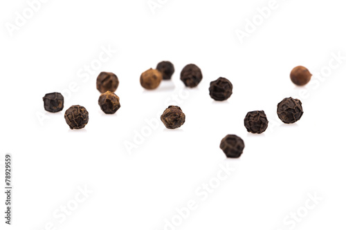 Black pepper seeds on white