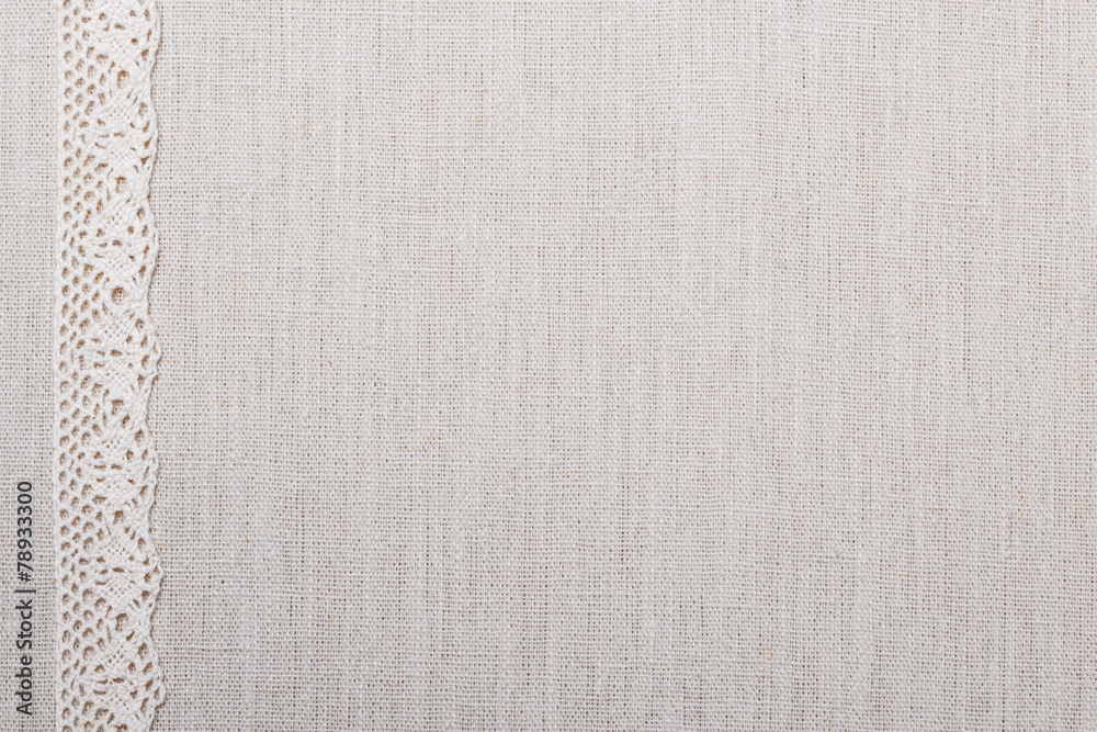 Fototapeta premium Lace ribbon on linen cloth background