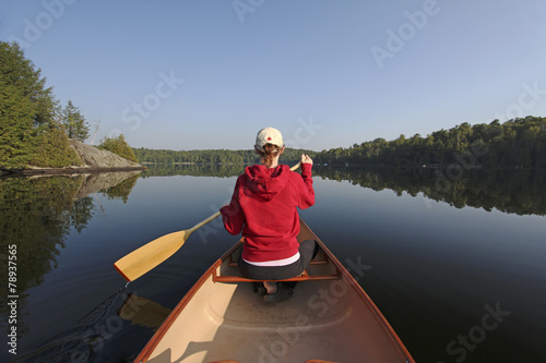 Woman  Paddling a Canoe on a Northern Ontario Lake