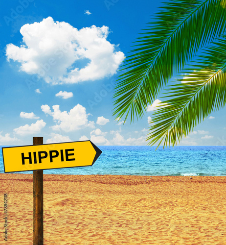 Tropical beach and direction board saying HIPPIE