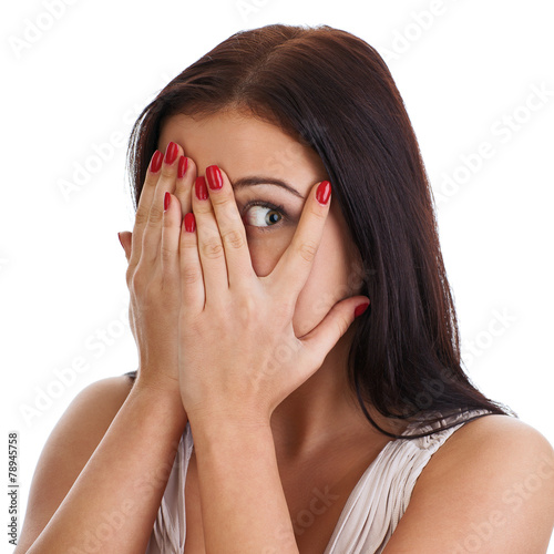 Afraid frightened woman peeking through her fingers.