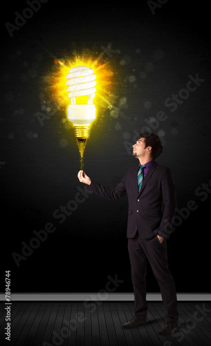 Businessman with an eco-friendly bulb