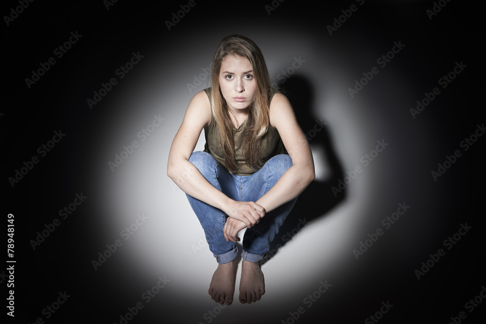 Sad Woman Sitting In Pool Of Light Sad Woman Sitting In Pool Of Light