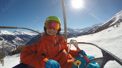 Skiing - young girl on ski lift