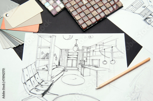 On the table are a drawing of pencil-drawn design room design. In the frame, a sheet of paper on a black background, a pencil and samples of the palette and mosaic.