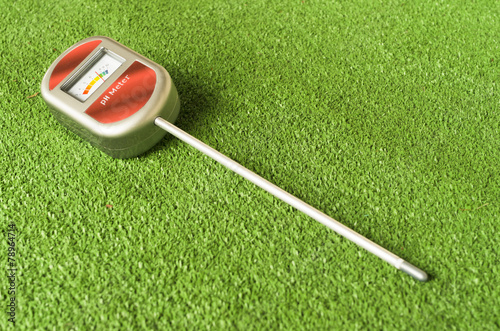 analog soil ph metering device on a green surface