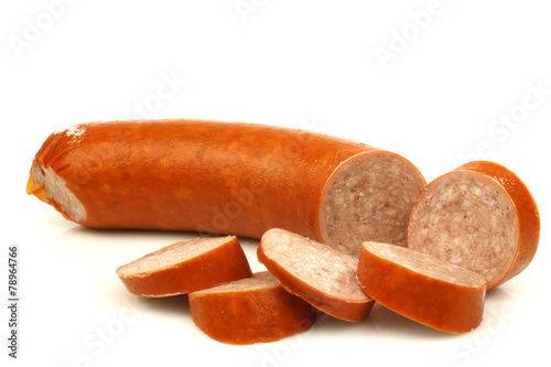 cut smoked sausage with some pieces on a white background photo