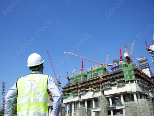 Construction worker looking at a building
