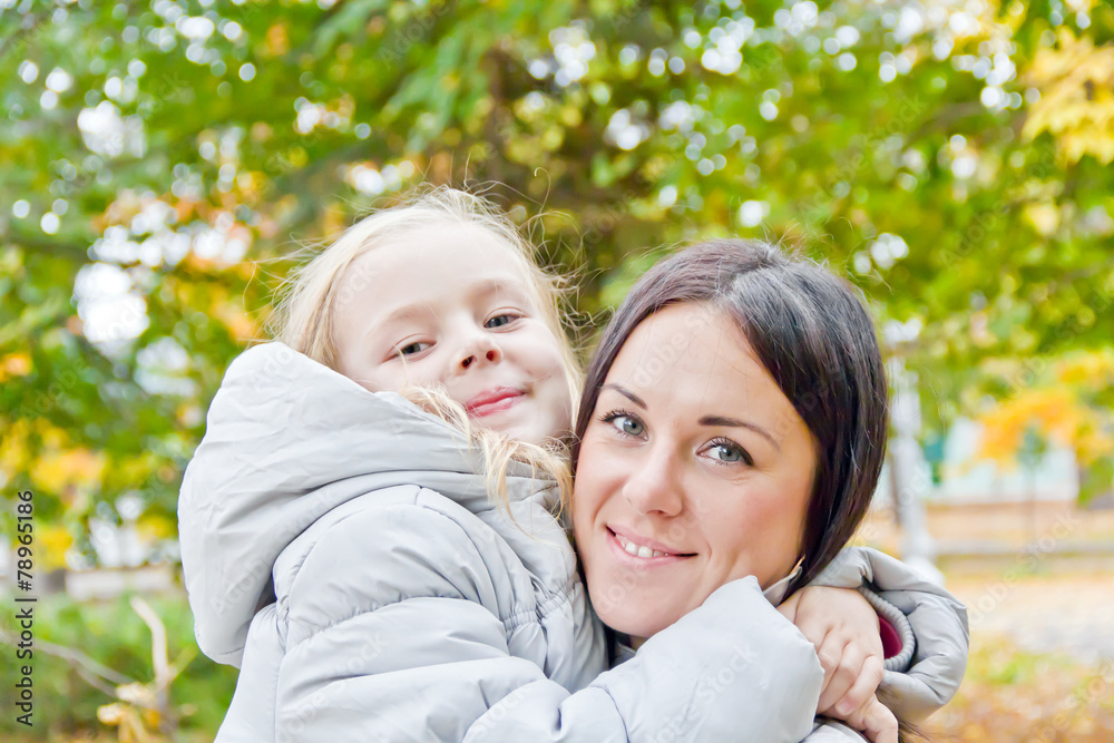 Mother and daughter in autumn