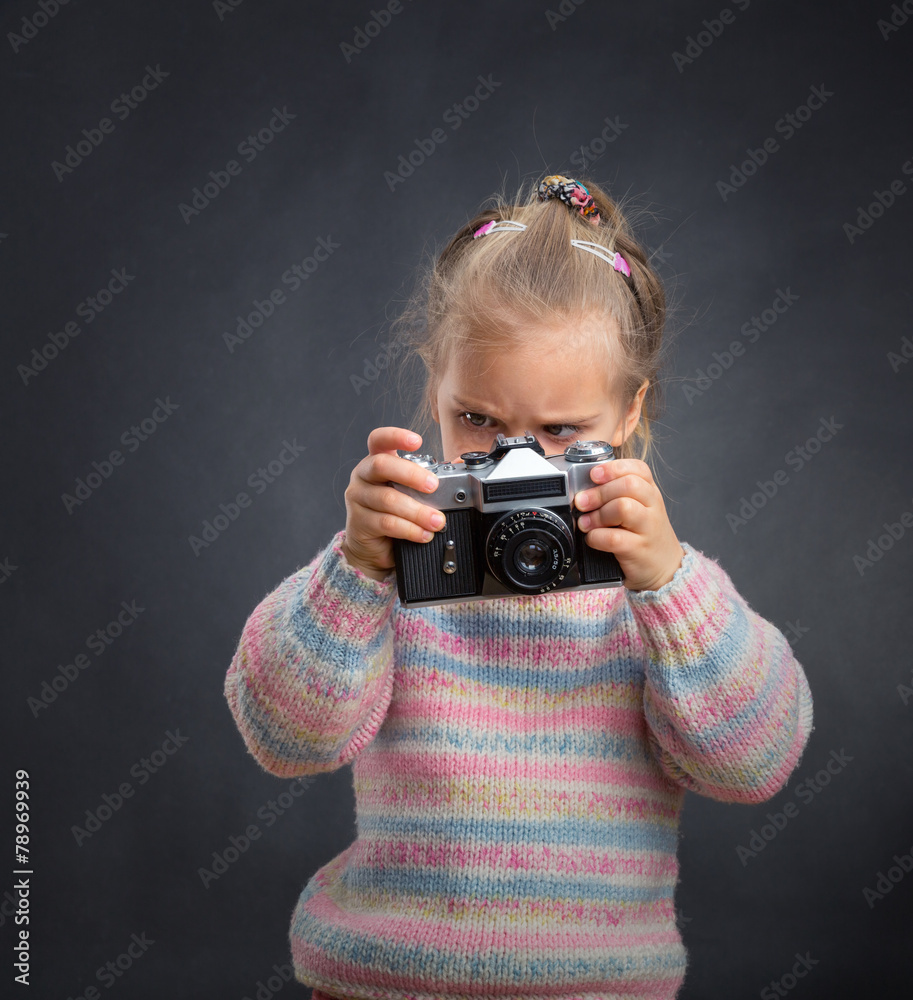 Little cute girl looks photos at the camera Little cute girl looks photos at the camera