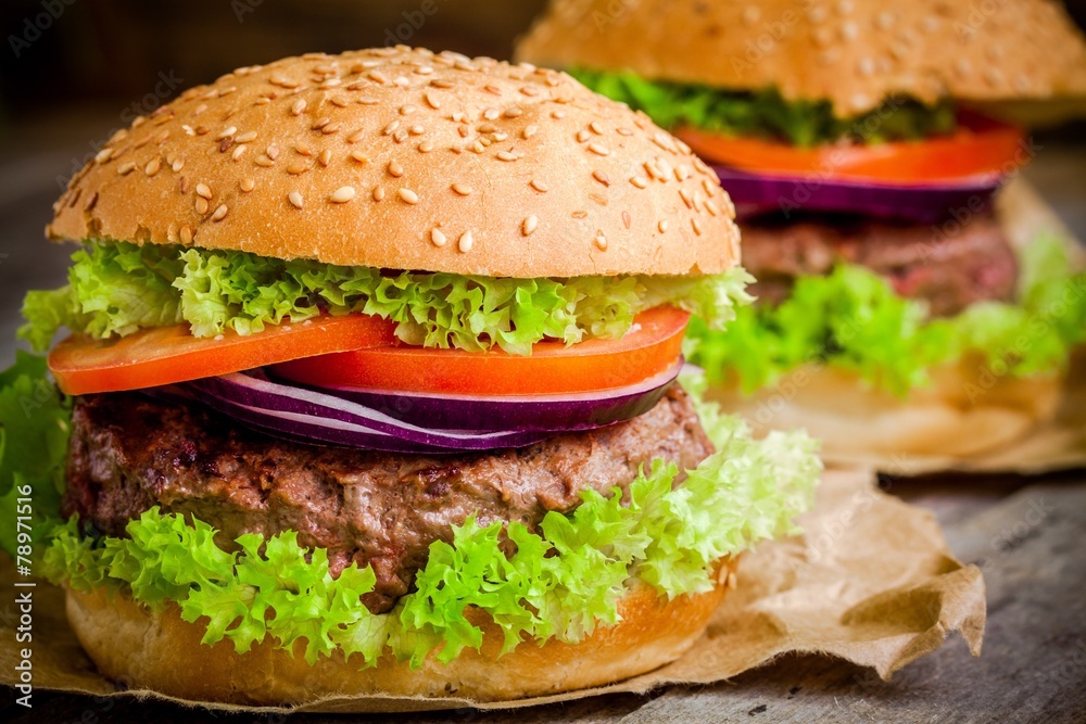 homemade hamburger with green lettuce, tomato and red onion homemade hamburger with green lettuce, tomato and red onion