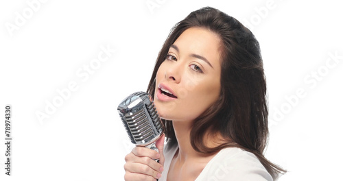 Preety woman singing into a microphone