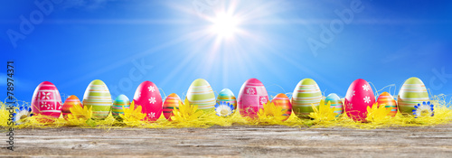 Photography eggs easter in row on straw - easter banner