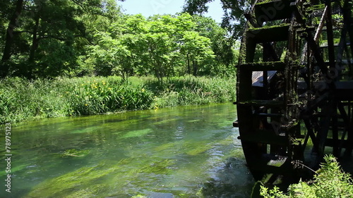 water wheel and clear stream photo