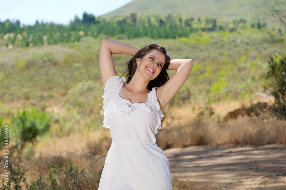 Happy smiling young woman enjoying nature