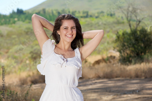 Beautiful carefree young woman smiling outdoors