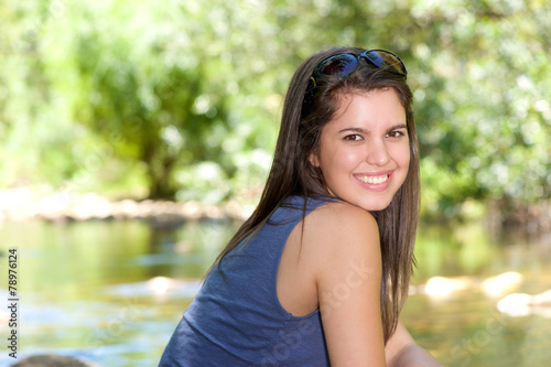 Friendly young woman smiling outdoors