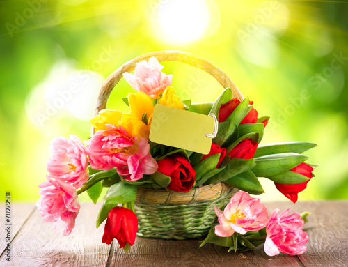 Fototapeta Naklejka Na Ścianę i Meble -  Basket of spring holiday flowers with greeting card