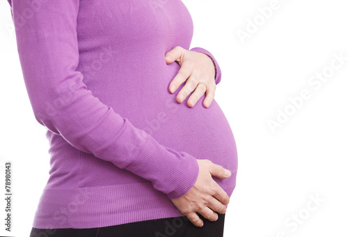 Unrecognizable pregnant woman isolated on a white background