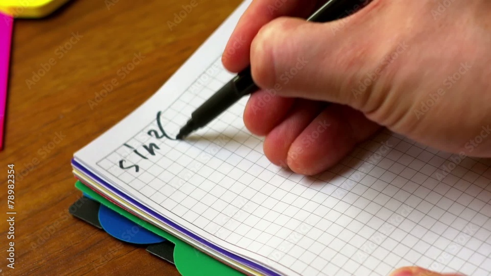A man writes on paper A man writes on paper