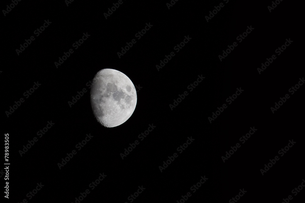 Waxing gibbous moon over dark sky at night Waxing gibbous moon over dark sky at night
