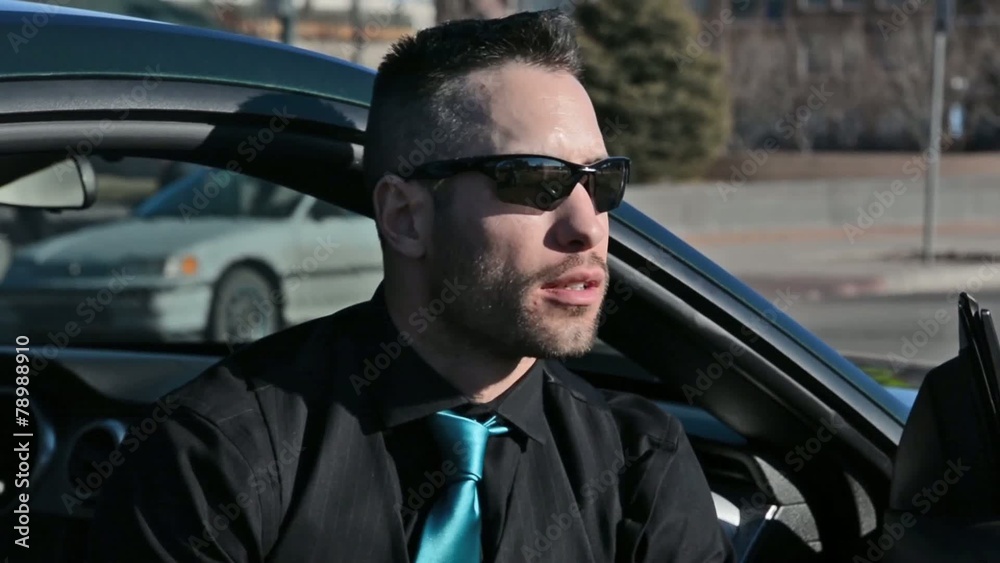 A handsome man waiting near his car A handsome man waiting near his car
