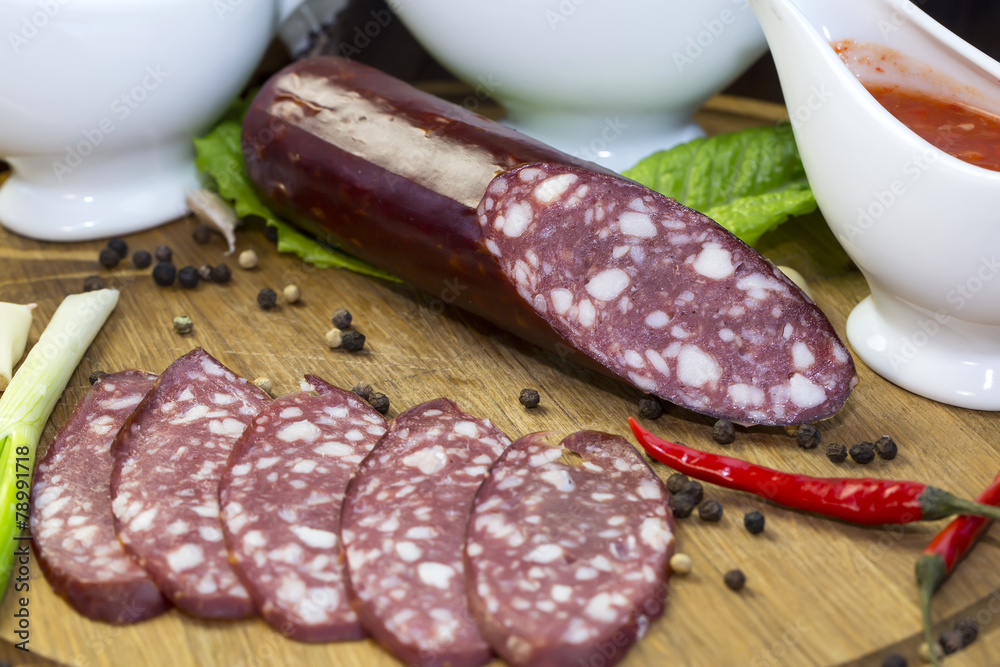 sausage on a wooden plate in a restaurant sausage on a wooden plate in a restaurant