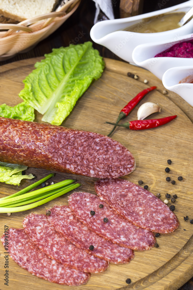 sausage on a wooden plate in a restaurant sausage on a wooden plate in a restaurant