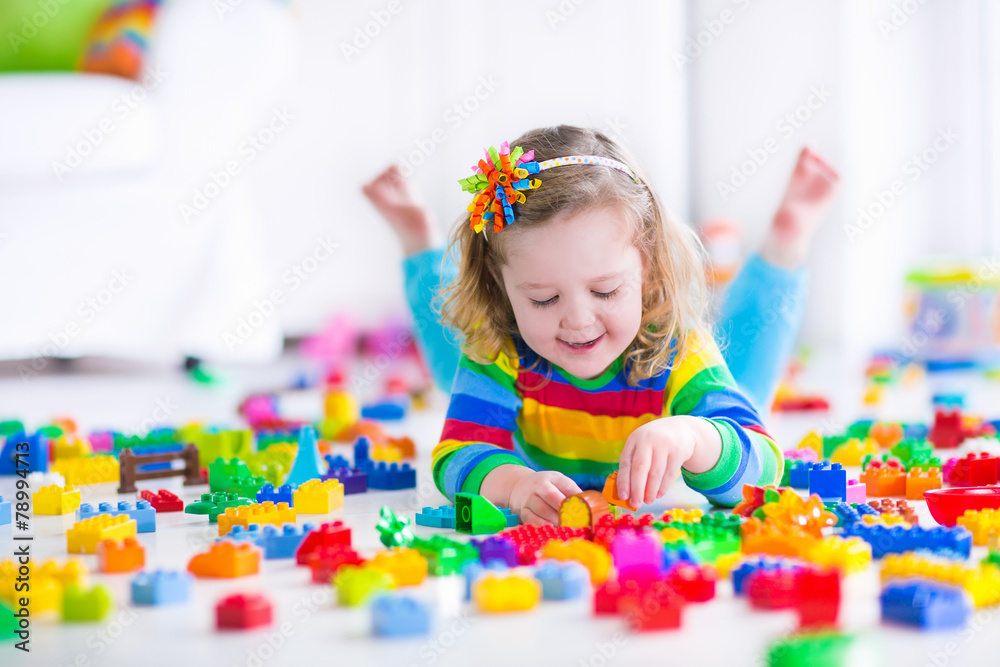 Little girl playing with toy blocks Little girl playing with toy blocks