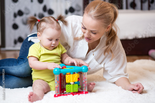mother and kid playing block toys at home