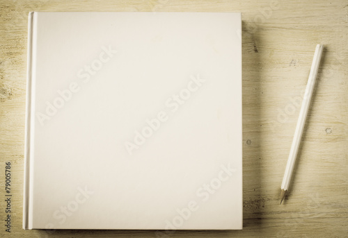 White book and white pencil