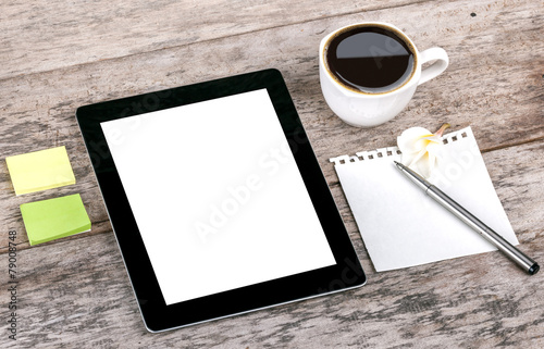digital tablet and coffee cup on wooden table