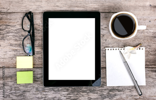 digital tablet and coffee cup on wooden table