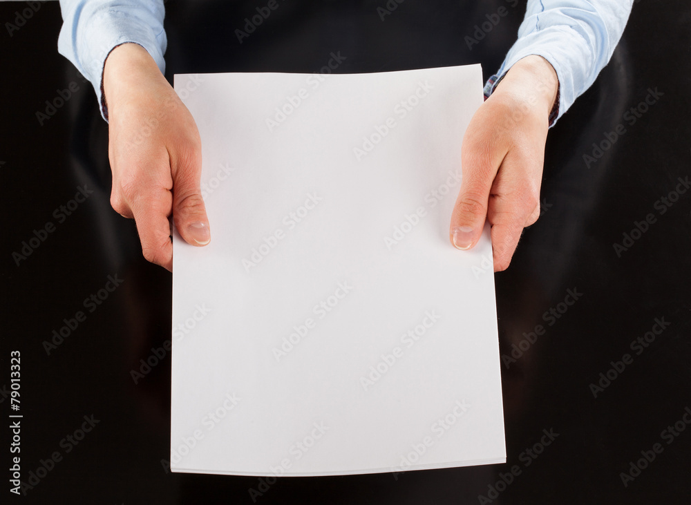 Hands holding blank sheet of paper Hands holding blank sheet of paper